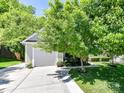 Inviting home exterior featuring a well-kept lawn and attached garage at 4143 Tullock Creek Dr, Charlotte, NC 28269