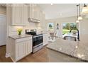 Modern kitchen featuring stainless steel appliances, granite countertops, and ample cabinet space at 498 Kenyon Dr, Denver, NC 28037