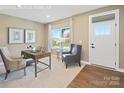 Bright home office with natural light, desk, and comfortable seating, creating an ideal workspace at 498 Kenyon Dr, Denver, NC 28037