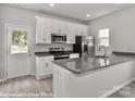 Modern kitchen with granite countertops and stainless steel appliances at 556 Ridge Ave, Mooresville, NC 28115