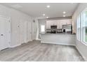 Open-concept living room with stainless steel appliances and ample natural light at 556 Ridge Ave, Mooresville, NC 28115