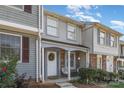 Charming two-story townhouse featuring a cozy front porch and decorative wreath on the front door at 7324 Pebblestone Dr # E, Charlotte, NC 28212