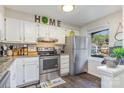 Well-lit kitchen features granite countertops, stainless steel appliances, and white cabinets at 7324 Pebblestone Dr # E, Charlotte, NC 28212