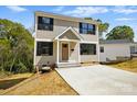 Charming two-story home showcasing neutral siding, black shutters, and a well-manicured front yard at 74 Snyder Ne Ct, Concord, NC 28025