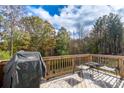 Spacious wooden back deck complete with patio furniture and a Weber grill, perfect for outdoor entertaining at 8419 Everwood Ave, Huntersville, NC 28078