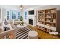 Bright living room features a fireplace, built-in shelving, and stylish decor for a comfortable and inviting space at 845 Creek Bluff Rd, Rock Hill, SC 29732