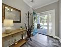 Welcoming foyer with hardwood floors, stylish decor, and a view of the beautiful front porch at 10416 Glenmac Rd, Charlotte, NC 28215