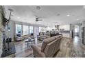 Spacious living room with hardwood floors and seamlessly open to the kitchen and dining areas at 10416 Glenmac Rd, Charlotte, NC 28215