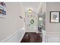 Welcoming foyer with hardwood floors, white wainscoting, and ample natural light, creating a warm entry at 10423 Drake Hill Dr, Huntersville, NC 28078