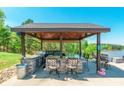 Gazebo overlooking a lake with barstool seating around a stone countertop at 1308 Twin Oaks Dr, Chester, SC 29706