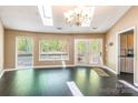 Bright living room featuring hardwood floors, skylights, and large windows showcasing serene outdoor views at 1308 Twin Oaks Dr, Chester, SC 29706