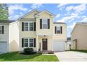 Charming two-story home with a well-maintained lawn and attached garage, perfect for suburban living at 13514 Tartarian Ct, Charlotte, NC 28215