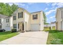 Inviting two-story home with a driveway and well-manicured lawn, nestled in a suburban neighborhood at 13514 Tartarian Ct, Charlotte, NC 28215
