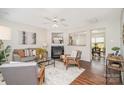 Bright living room with fireplace, ceiling fan and hardwood floors at 13514 Tartarian Ct, Charlotte, NC 28215