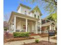 Inviting two-story home boasts a spacious front porch, perfect for relaxing and enjoying the neighborhood at 140 Parkview St, Davidson, NC 28036