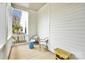 Cozy side porch with seating, offering a tranquil outdoor retreat with a view of the yard at 140 Parkview St, Davidson, NC 28036