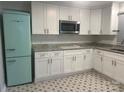 Modern kitchen with white cabinets, retro refrigerator, and granite countertops at 1401 Anderson St, Charlotte, NC 28205