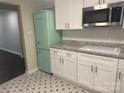 Bright kitchen with white cabinetry, stainless microwave and a retro refrigerator at 1401 Anderson St, Charlotte, NC 28205