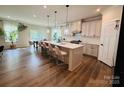 Spacious kitchen with a large island, modern pendant lighting, and stainless steel appliances at 1408 Augustus Beamon Dr, Charlotte, NC 28079