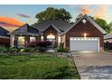 Beautiful brick home featuring an attached two-car garage and a well-maintained front lawn at 1511 Elkhart Cir, Gaston, NC 28054