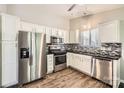 Modern kitchen featuring stainless steel appliances, white cabinetry, and a stylish backsplash at 1807 Oakdale Green Dr, Charlotte, NC 28216