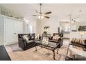 Cozy living room featuring comfortable leather furniture, ceiling fan, and open access to the kitchen at 1807 Oakdale Green Dr, Charlotte, NC 28216