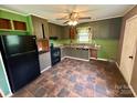 Functional kitchen with tile floors, black appliances and ample cabinet space at 181 Canipe Rd, Dallas, NC 28034