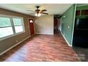 Inviting living room featuring wood-look flooring, neutral walls, and a ceiling fan at 181 Canipe Rd, Dallas, NC 28034