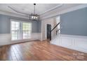 Bright dining room with hardwood floors, large window and detailed wall trim, perfect for Gathering gatherings at 1811 Robbins Meadows Dr, Waxhaw, NC 28173