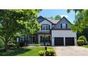 Charming home with a manicured lawn, a two-car garage and a welcoming front porch at 1811 Robbins Meadows Dr, Waxhaw, NC 28173