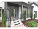 Inviting front porch with elegant iron railings and manicured landscaping, offering a welcoming entrance to the home at 1811 Robbins Meadows Dr, Waxhaw, NC 28173