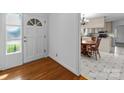 Inviting foyer with hardwood floors transitioning into a dining area with a classic table and kitchen view at 1860 Rosemont St, Salisbury, NC 28144