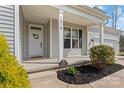 Inviting front porch with white columns, a wreath on the door, and well-manicured landscaping at 1870 Beth Haven Church Rd, Denver, NC 28037