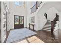 Bright foyer with hardwood floors, staircase, and modern decor provides a grand entrance at 1976 Ferncliff Rd, Charlotte, NC 28211