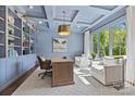 Stylish office with custom built-ins, coffered ceiling, and ample natural light at 1976 Ferncliff Rd, Charlotte, NC 28211