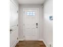 Bright entryway with white door, white walls and luxury vinyl plank flooring at 2051 Langer St, Charlotte, NC 28214