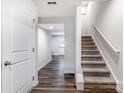 Open hallway with luxury vinyl plank flooring, staircase, and doorway at 2051 Langer St, Charlotte, NC 28214