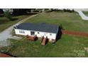 Aerial view of a home's backyard featuring a fenced yard, patio, and ample green space at 2055 Cauble Rd, Salisbury, NC 28144