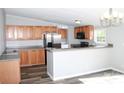 Modern kitchen with stainless steel appliances, wood cabinets, and a breakfast bar at 2055 Cauble Rd, Salisbury, NC 28144