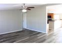 Bright living room with a ceiling fan and new flooring, flowing into an open kitchen area at 2055 Cauble Rd, Salisbury, NC 28144