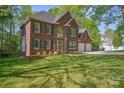 A distinguished brick home with well-maintained lawn with a two-car garage at 210 35Th Ne Ave, Hickory, NC 28601
