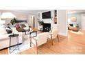 Bright and airy living room with hardwood floors, a fireplace, built-in shelving, and comfortable seating at 2121 Arnold Dr, Charlotte, NC 28205