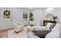 Cozy living room with modern decor, featuring neutral tones, wood floors, and large windows at 261 8Th Avenue Se Dr, Hickory, NC 28602