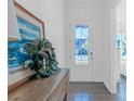 Bright entryway featuring a decorative painting, dark hardwood floors, and a view of the outdoors at 3012 Laney Pond Rd, Matthews, NC 28104