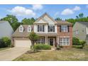 Charming two-story home with manicured lawn, traditional brick, and neutral siding at 3131 Arborhill Rd, Charlotte, NC 28270