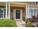 Inviting front entry with black door, classic wreath, and beautiful landscaping at 3131 Arborhill Rd, Charlotte, NC 28270