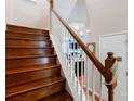Wooden staircase with white spindles leading to the upper level at 3246 Yarmouth Ln, Gastonia, NC 28056