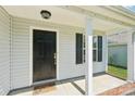 Charming covered porch and black front door welcome you home at 3335 Hawick Commons Dr, Concord, NC 28027