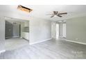 Open living area featuring modern flooring that flows into the kitchen with white cabinets at 340 Whitner St, Rock Hill, SC 29730