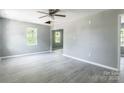 Bright living room with gray walls, modern floors, ceiling fan, and lots of natural light at 340 Whitner St, Rock Hill, SC 29730